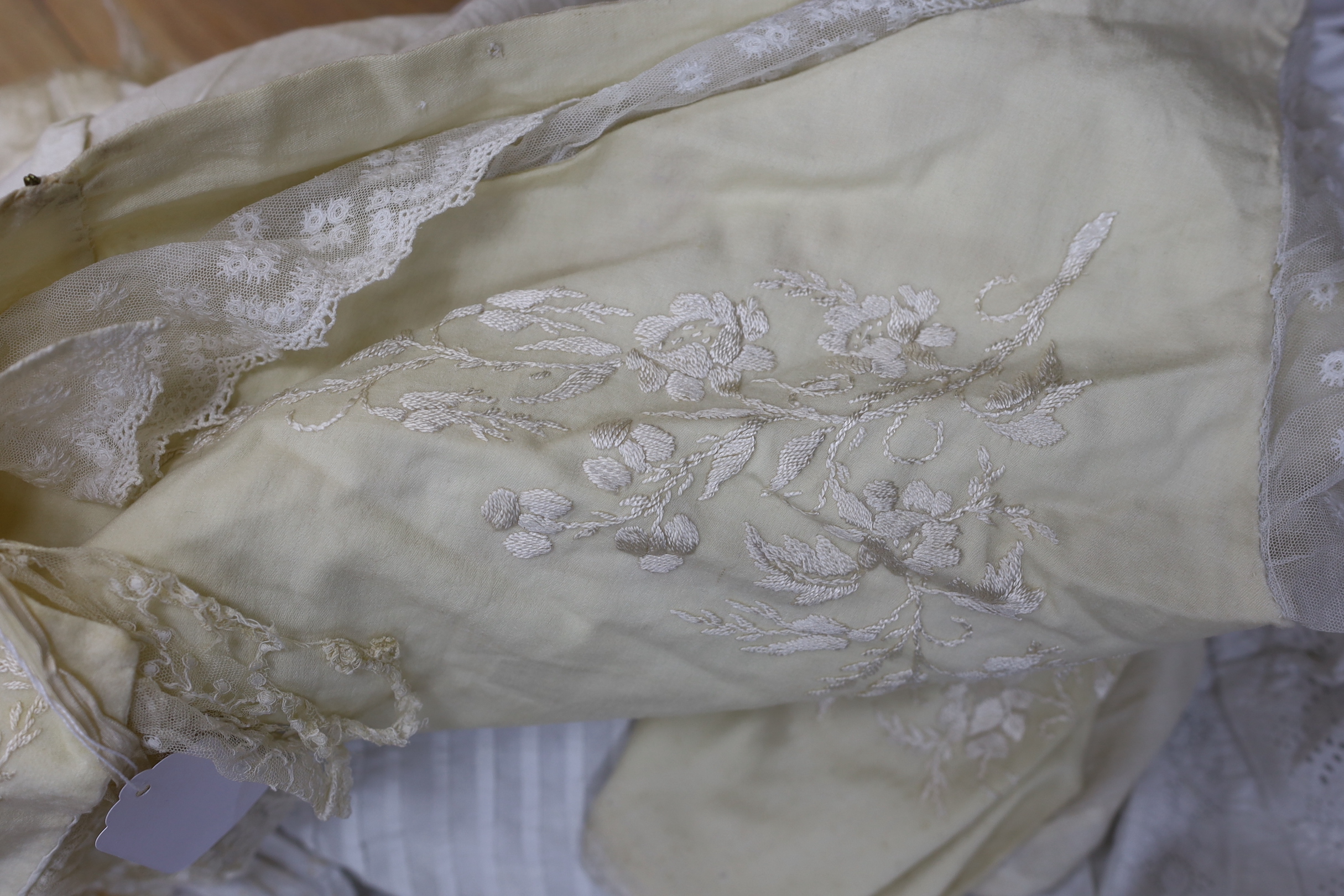 Three Victorian white worked christening gowns, two similar girls aprons and a christening cape